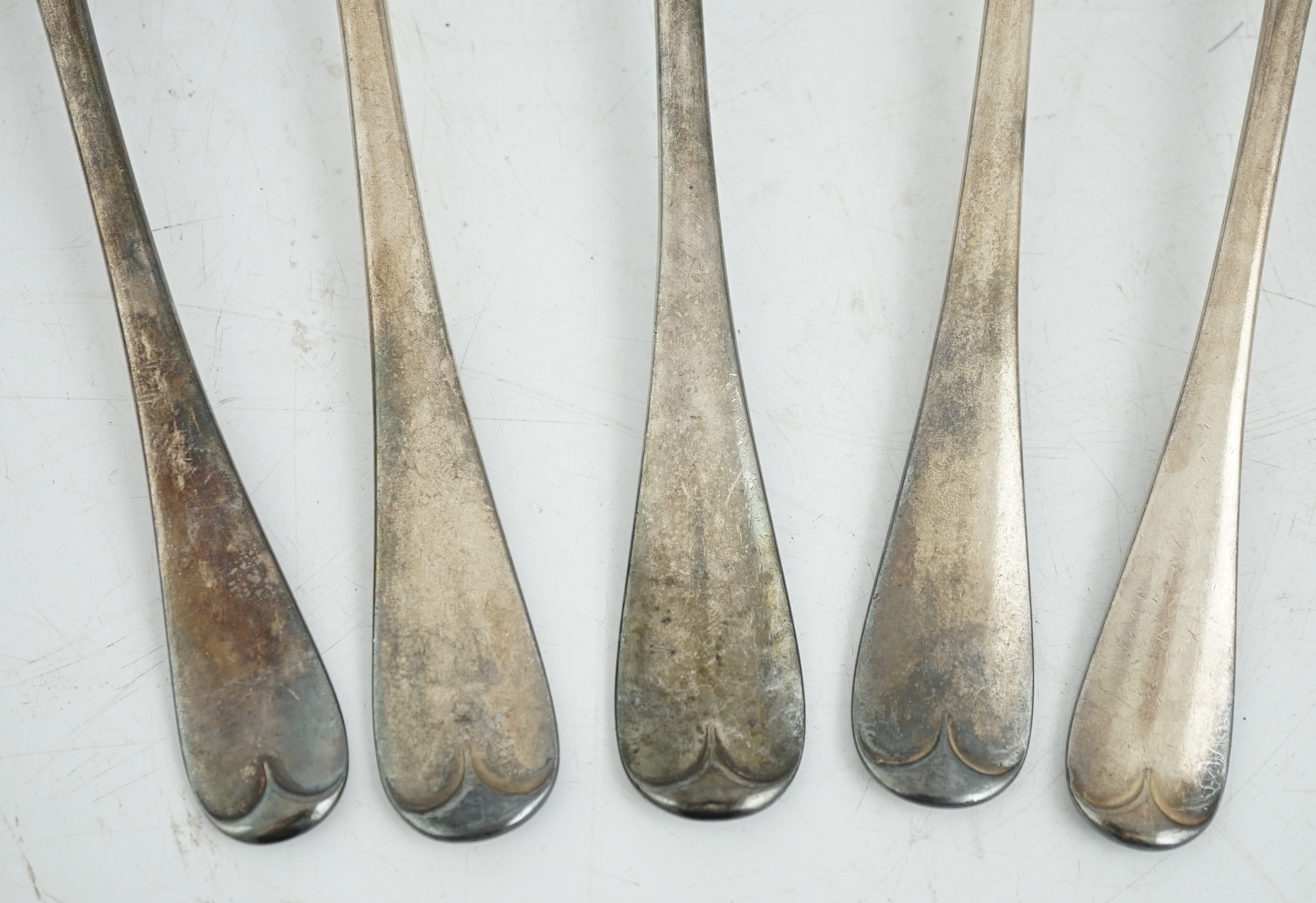 Sundry silver, consisting of three pieces of George III flatware, two 800 standard coffee spoons, a pair of candlesticks(a.f.), a lidded glass preserve pot, clothes brush, two pepperettes and a desk seal.